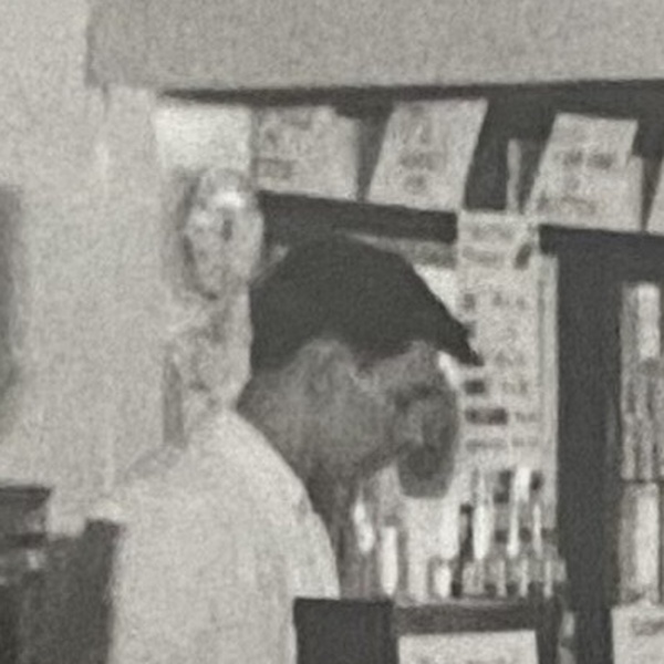 Unidentified man standing behind the counter at V C Jones, Harbour Street, Whitstable