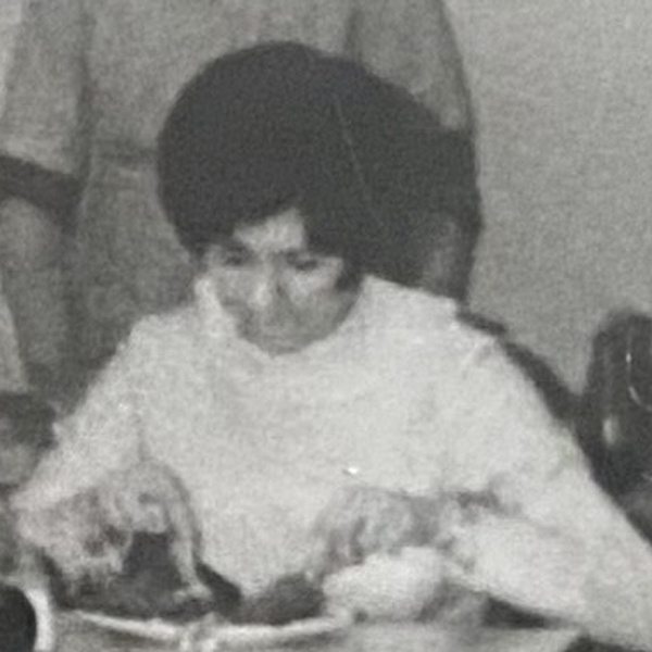 Unidentified woman with a dark bob eating lunch at a table inside V C Jones, Harbour Street, Whitstable